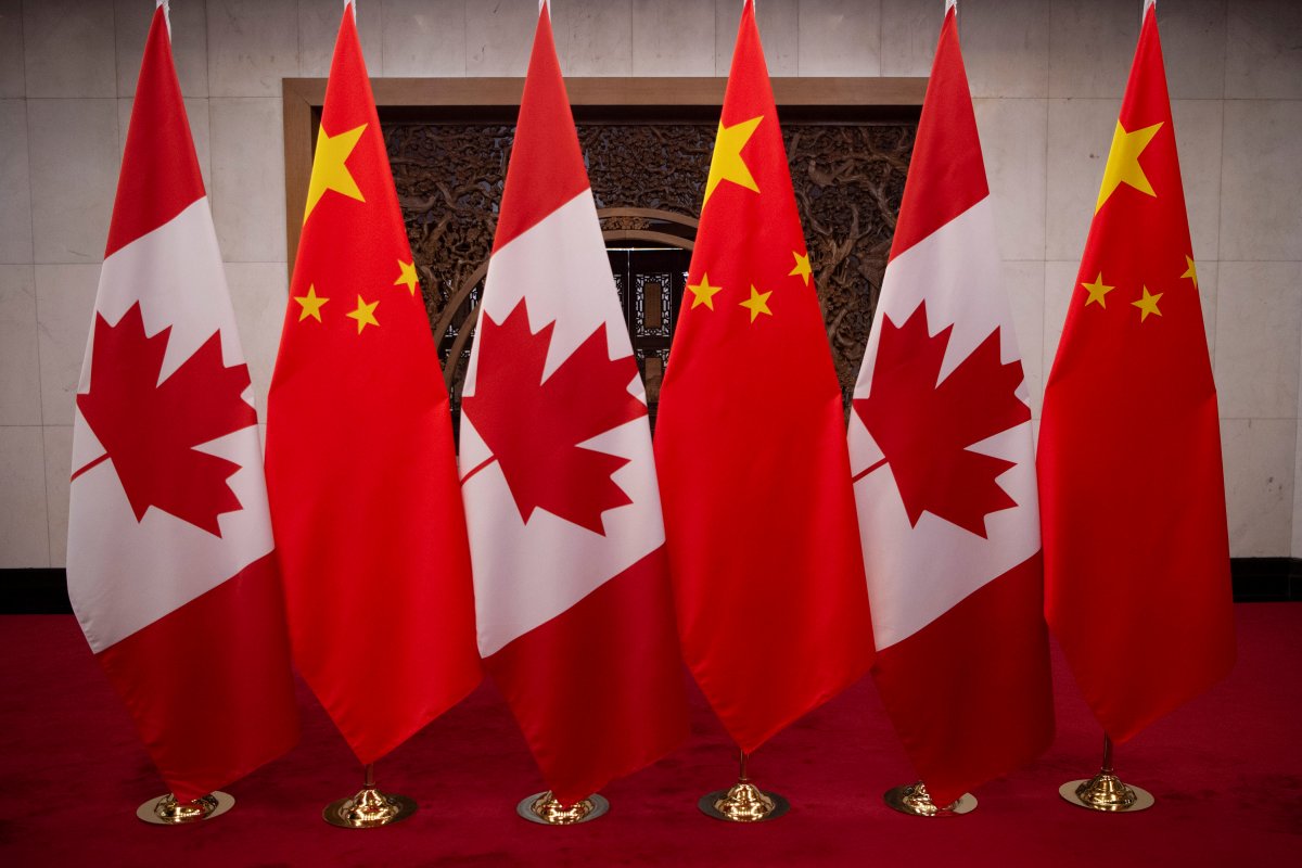 Canadian and Chinese flags stand side by side ahead of a press conference