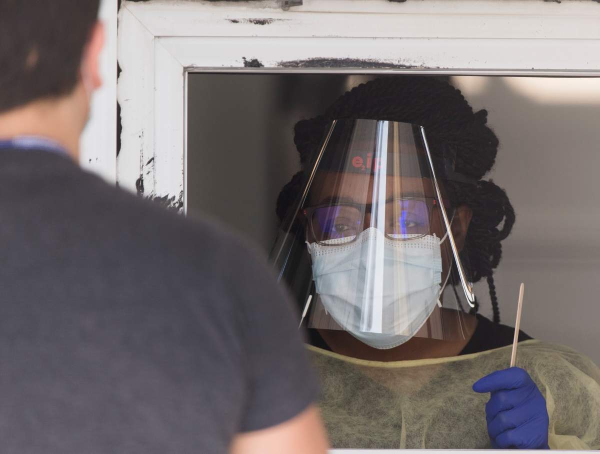 A health-care worker prepares to give a COVID-19 test at a clinic in Montreal North, Saturday, May 2, 2020, as the COVID-19 pandemic continues in Canada and around the world.