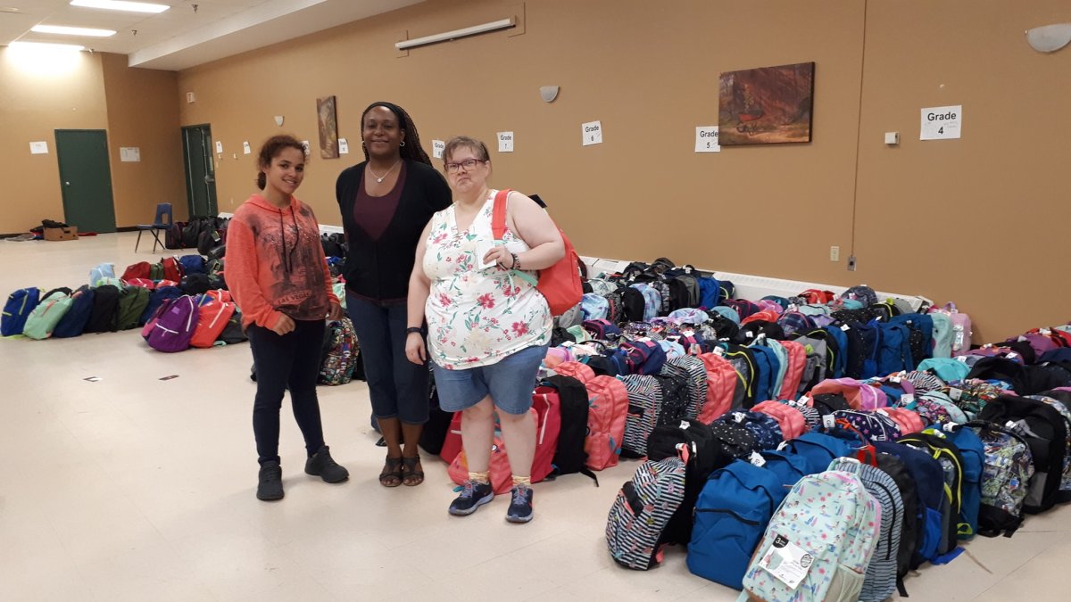 Parker Street Food & Furniture Bank volunteers organize school supply donations during the 2019 Back to School Supply Drive.