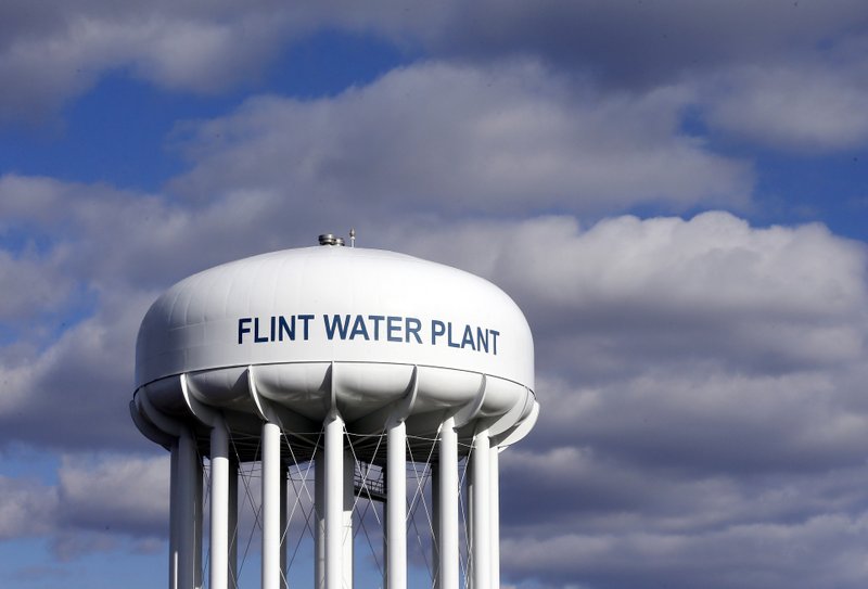 FILE - In this March 21, 2016, file photo, the Flint Water Plant water tower is seen in Flint, Mich. Multiple news outlets report Wednesday, Aug. 19, 2020, that the state of Michigan has reached a $600 million agreement to compensate Flint residents whose health was damaged by lead-tainted drinking water. 