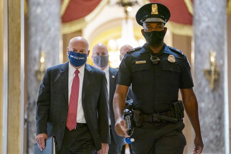 Postmaster General Louis DeJoy, left, is escorted to House Speaker Nancy Pelosi's office on Capitol Hill in Washington, Wednesday, Aug. 5, 2020. Facing public backlash, DeJoy is set to testify Friday about disruptions in mail delivery. 