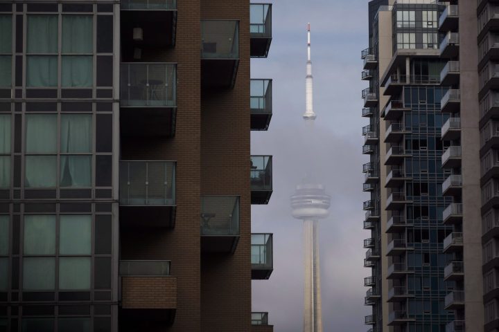 The CN Tower can be seen behind condo's in Toronto's Liberty Village community in Toronto, Ontario on Tuesday, April 25, 2017. 