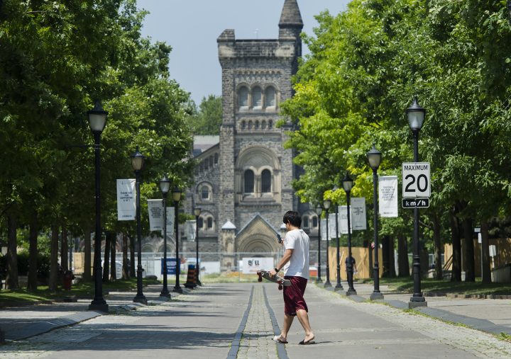 A person walks past the University of Toronto campus during the COVID-19 pandemic in Toronto on Wednesday, June 10, 2020. 