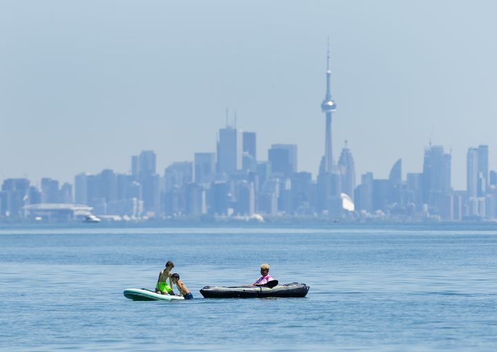 People enjoy activities on Lake Ontario overlooking the city of Toronto skyline at Jack Darling Park in Mississauga on Wednesday, June 17, 2020. 