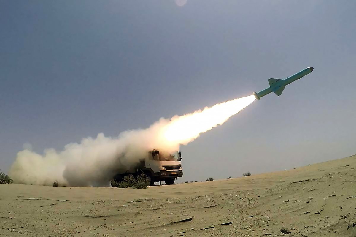 A missile being fired out to sea from a mobile launch vehicle reportedly on the southern coast of Iran along the Gulf of Oman during a military exercise. 