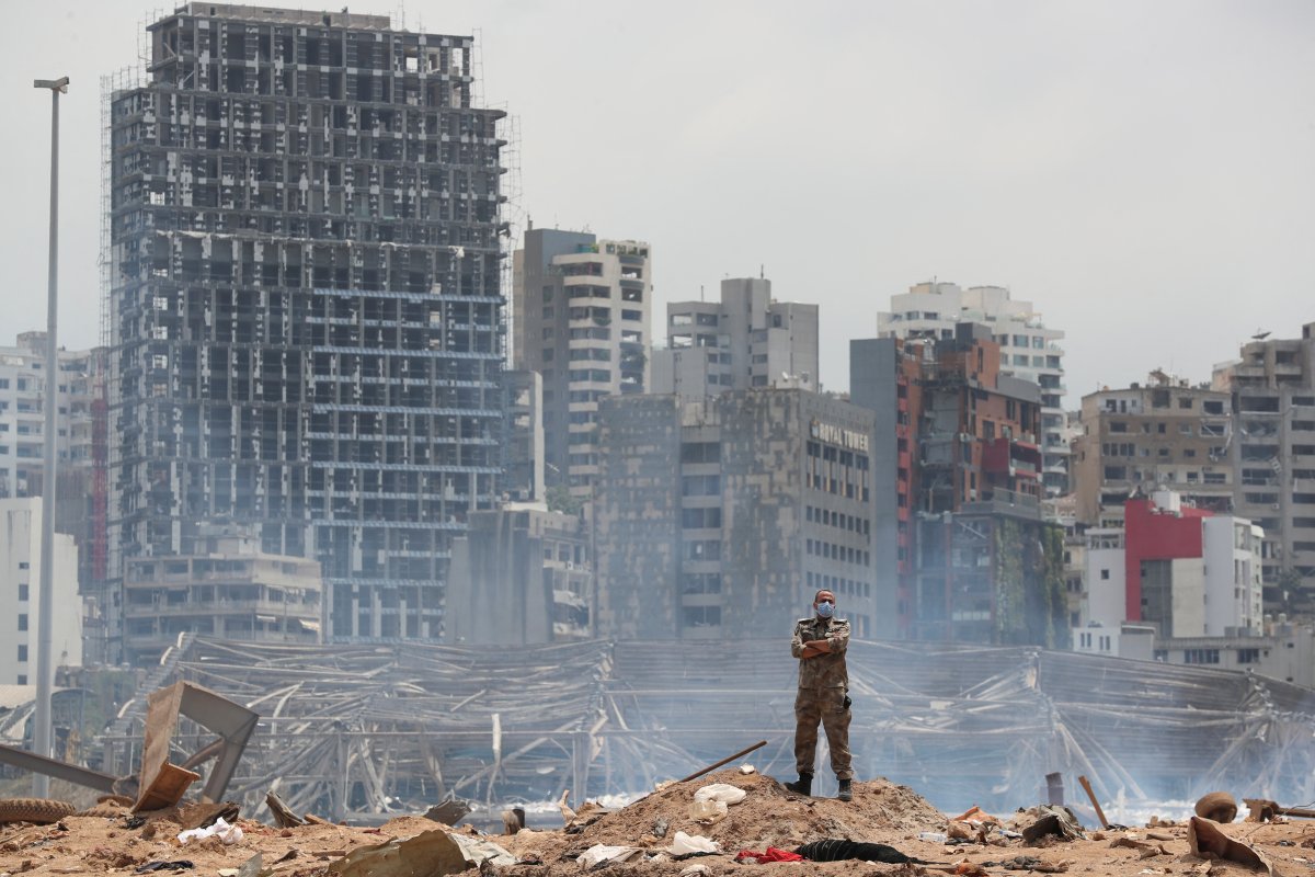 A soldier stands at the devastated site of the explosion in the port of Beirut, Lebanon, Thursday, Aug. 6, 2020.