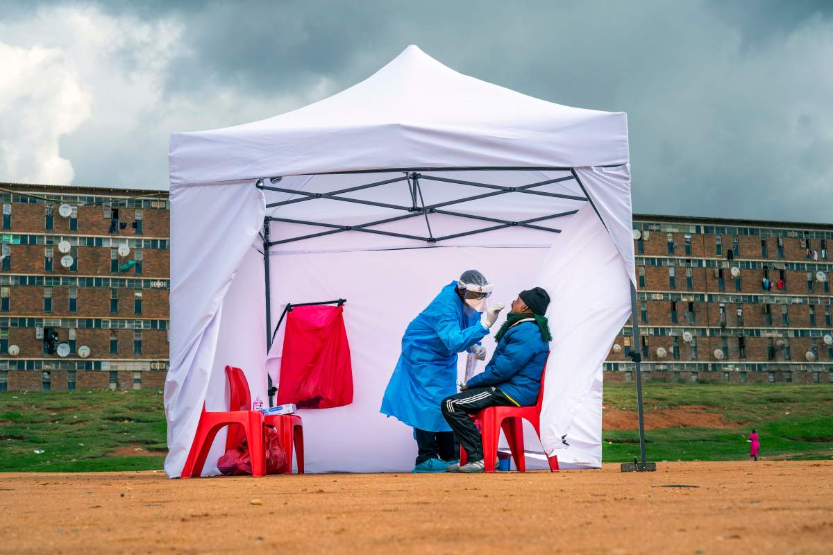 FILE - In this April 29 2020, file photo, a resident from the Alexandra township gets tested for COVID-19, in Johannesburg, South Africa.