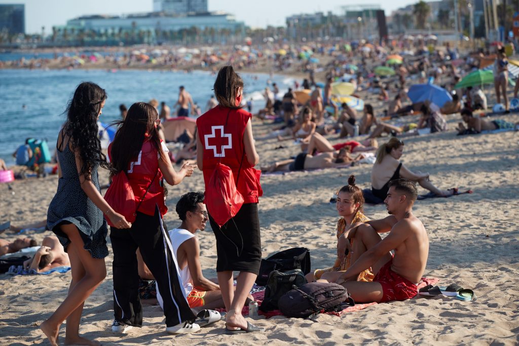 Spanish Red Cross members take part in a campaign to raise awareness among young people to avoid further spread of the coronavirus COVID-19 virus in Barcelona, Catalonia, Spain, 07 August 2020.  