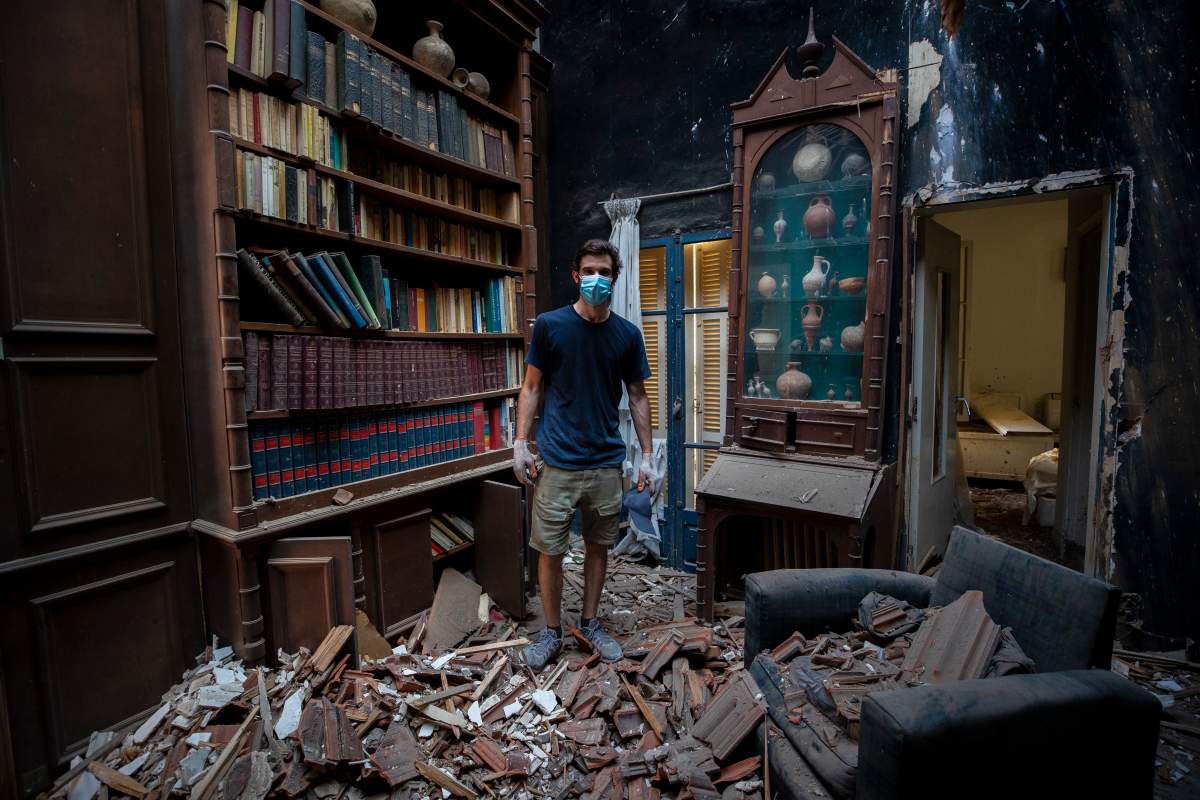 Said Al Assaad, 24, poses for a photograph inside his grandfather’s destroyed villa after Tuesday’s explosion in the seaport of Beirut, Lebanon, Aug. 6, 2020.