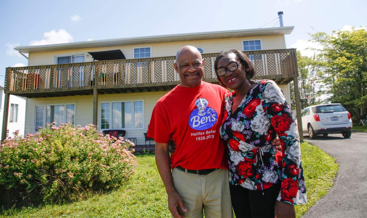 Christopher Downey and his wife Chrissy pose in front of their home in North Preston, N.S., Saturday, August 1, 2020. Christopher Downey finished building his home in 2002 on a parcel of land in North Preston, N.S., that has been in his family for generations. But it was only in late July that Downey says he found out the province intends to issue him a certificate of claim to the land upon which his house was built, the first step in his years-long fight for title.