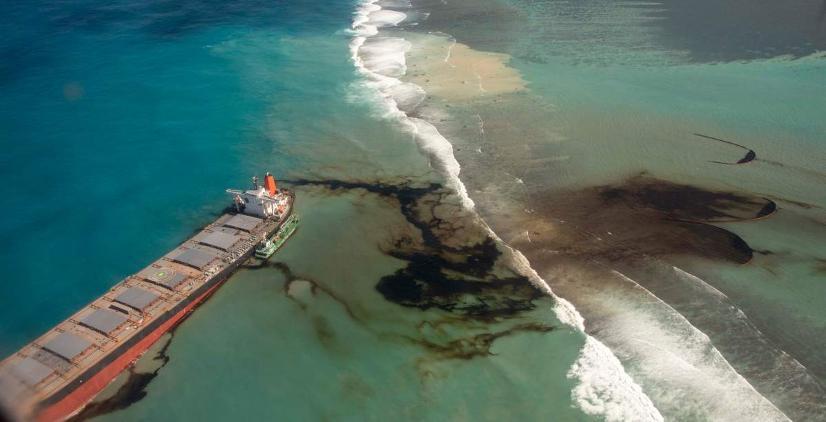 This photo provided by the French Defense Ministry shows oil leaking from the MV Wakashio, a bulk carrier ship that recently ran aground off the southeast coast of Mauritius, Sunday Aug. 9, 2020. The Indian Ocean island of Mauritius has declared a “state of environmental emergency” after the Japanese-owned ship that ran aground offshore days ago began spilling tons of fuel.