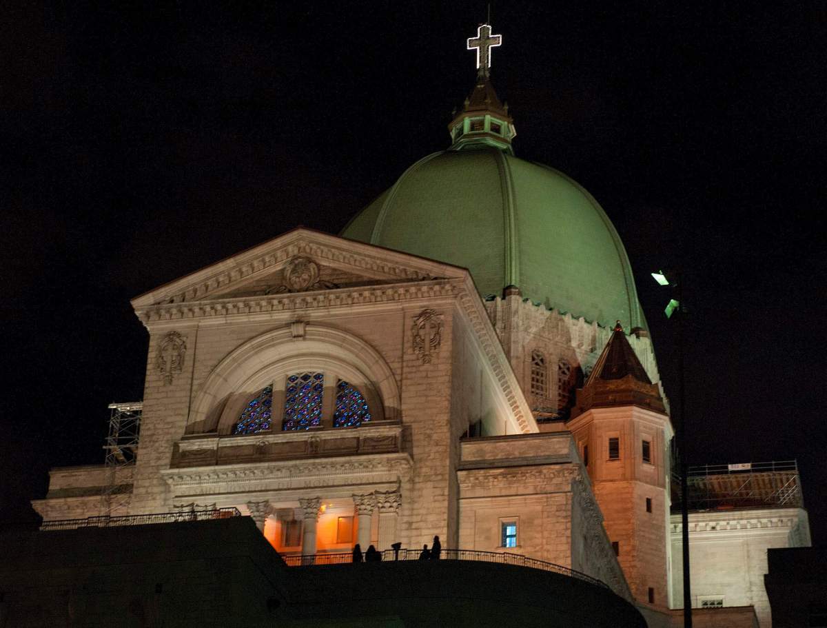People stand outside the Saint Joseph Oratory in Montreal on October 16, 2010. 
