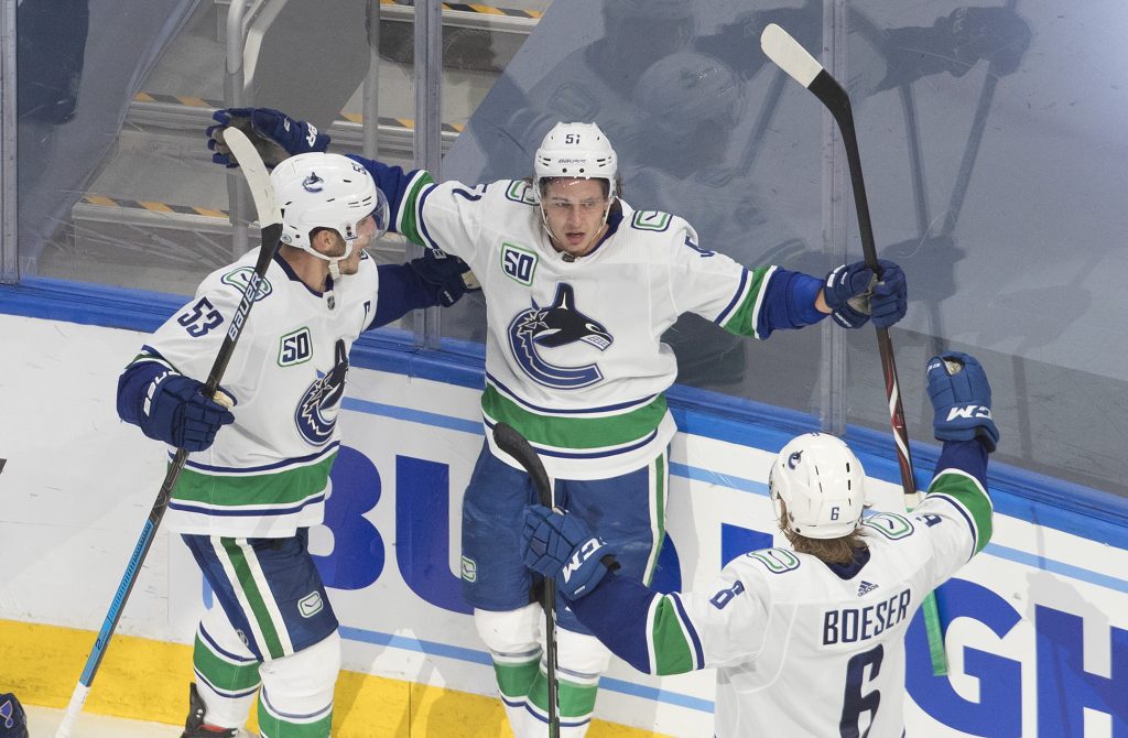 Vancouver Canucks' Bo Horvat (53), Troy Stecher (51) and Brock Boeser (6) celebrate a goal against the St. Louis Blues during the third period of a first round NHL Stanley Cup playoff hockey series in Edmonton, on Wednesday August 12, 2020. 