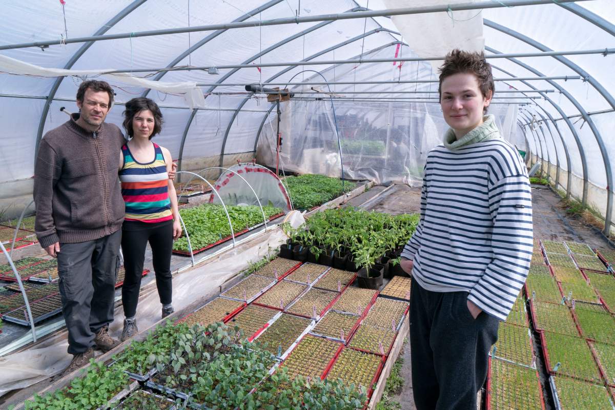 Farm owners Francois Daoust and Melina Plante, left, are seen in their greenhouse with summer employee Florence Lachapelle in Havelock, Que., on Thursday, April 23, 2020. 