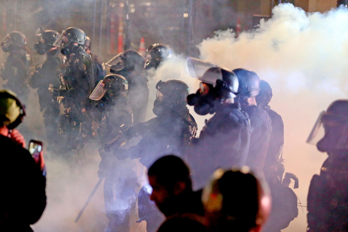 Portland police and protesters clash during a demonstration, early Thursday Aug. 13, 2020, in downtown, Portland.
