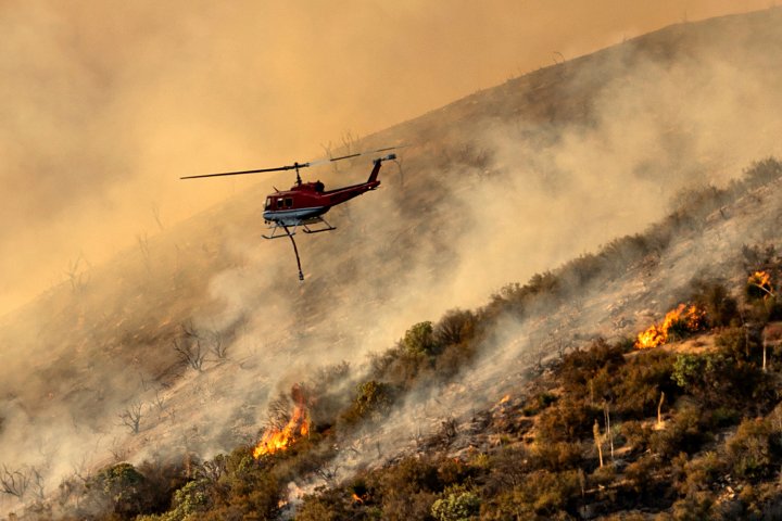 Crews scramble as massive California wildfire burns homes, new fires start