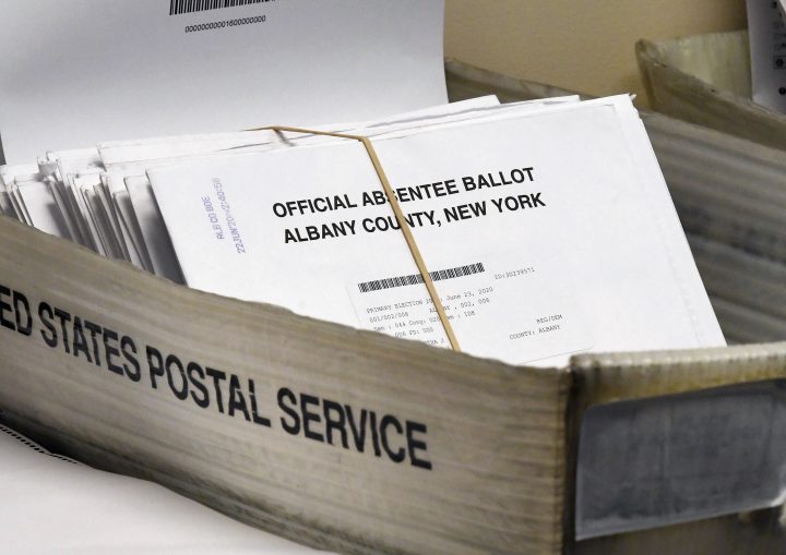 FILE - In this June 30, 2020, file photo, a box of absentee ballots wait to be counted at the Albany County Board of Elections in Albany, N.Y.