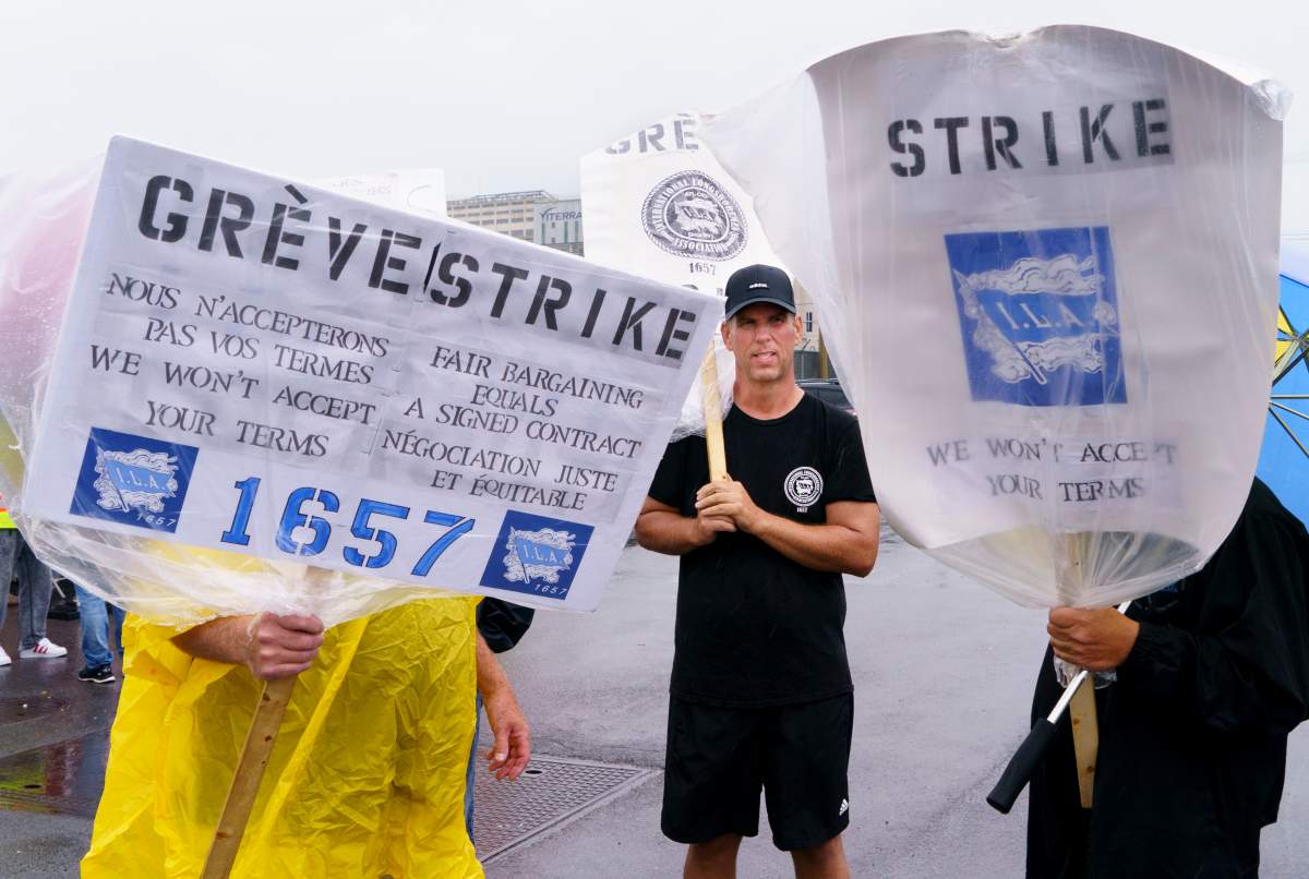 Striking Port of Montreal workers walk the picket line in Montreal on Monday, Aug. 17, 2020. 