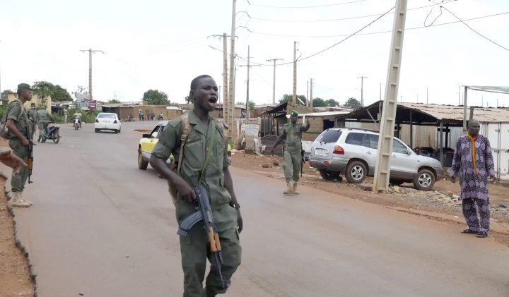 In this image made from video, Malian troops, believed to be part of a detachment possibly mutinying, man an impromptu checkpoint and stop and search traffic in Kati, Mali Tuesday, Aug. 18, 2020. 