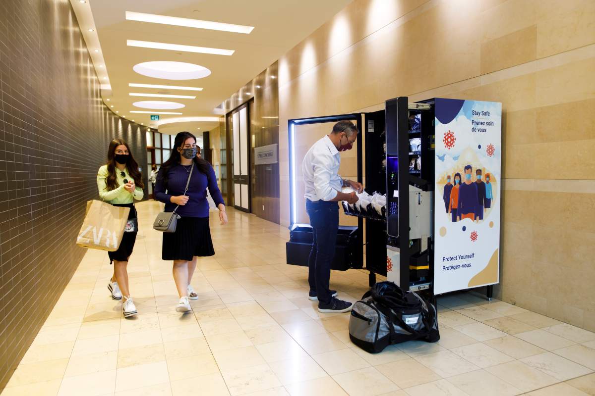 Gilad Levy refills a PPE vending machine at Yorkdale Shopping Centre in Toronto, Thursday, Aug. 13, 2020. THE CANADIAN PRESS/Cole Burston