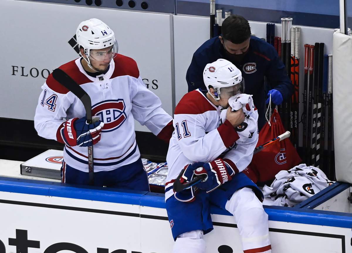 Montreal Canadiens right wing Brendan Gallagher (11) holds a towel on his mouth as Canadiens centre Nick Suzuki (14) checks on him after defeating the Philadelphia Flyers during NHL Eastern Conference Stanley Cup playoff hockey action in Toronto on Wednesday, August 19, 2020. 