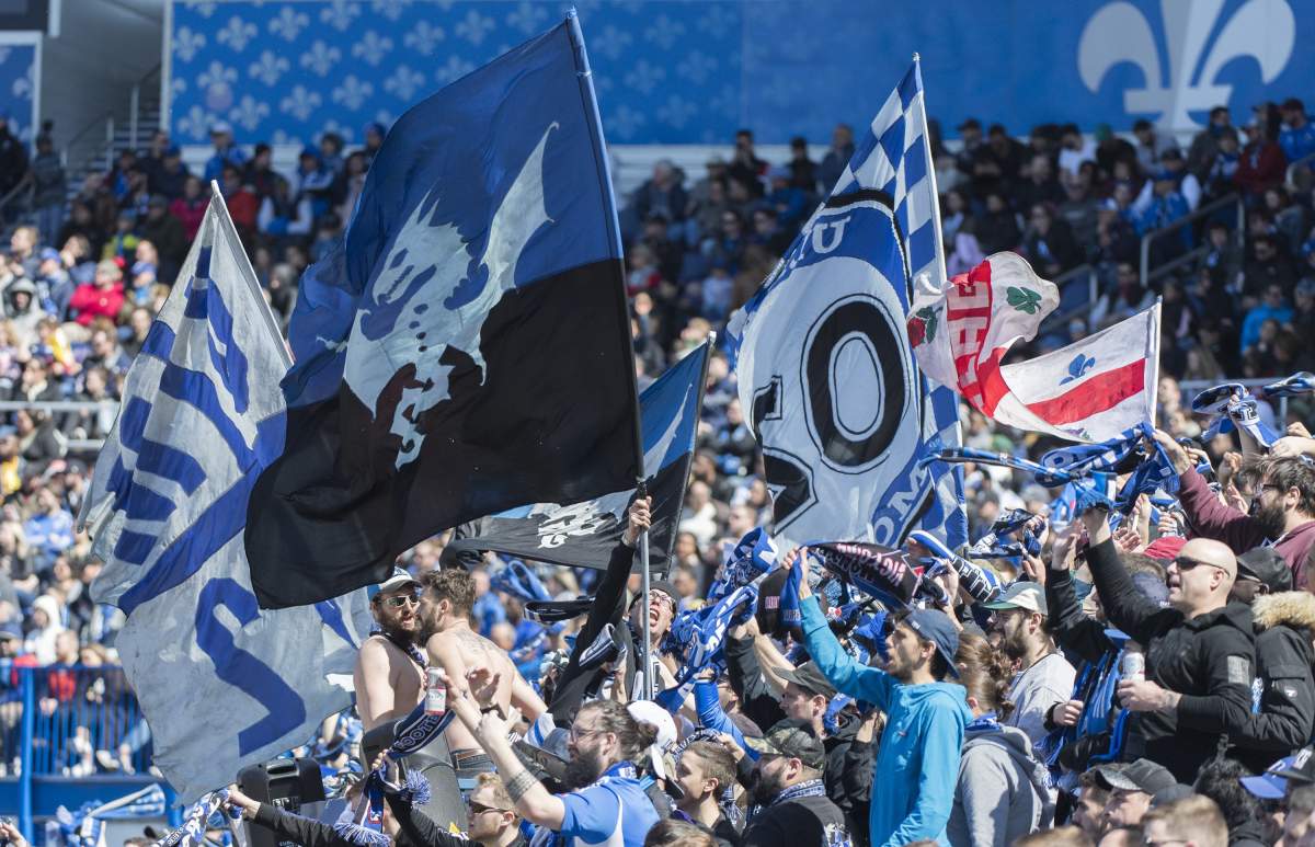Montreal Impact fans cheer on their team during second half MLS soccer action against Columbus Crew SC in Montreal, Saturday, April 13, 2019. The Montreal Impact say they will have some fans at their first Major League Soccer home game during the COVID-19 pandemic next week. The club says a maximum of 250 people will be allowed in 20,081-seat Stade Saputo when the Impact face the Vancouver Whitecaps next Tuesday. 