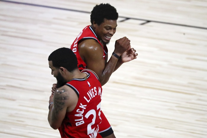 Toronto Raptors guard Fred VanVleet (23) celebrates with guard Kyle Lowry (7) after making a half court shot against the Brooklyn Nets to end the first half in Game 3 of an NBA basketball first-round playoff series, Friday, Aug. 21, 2020, in Lake Buena Vista, Fla. 