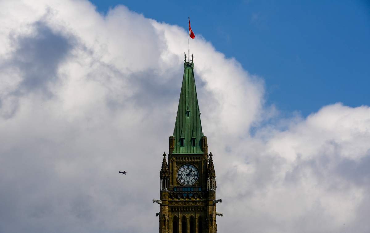 A small tourist plane passes over downtown Ottawa at Parliament Hill on Monday, Aug. 24, 2020.  