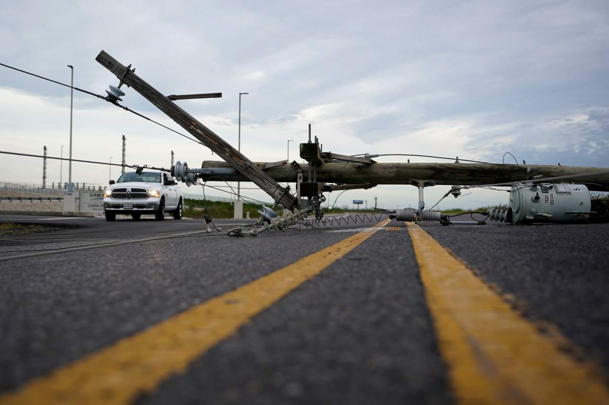 Down power lines stretch across a road in the aftermath of hurricane Laura Thursday, Aug. 27, 2020, in Sabine Pass, Texas.