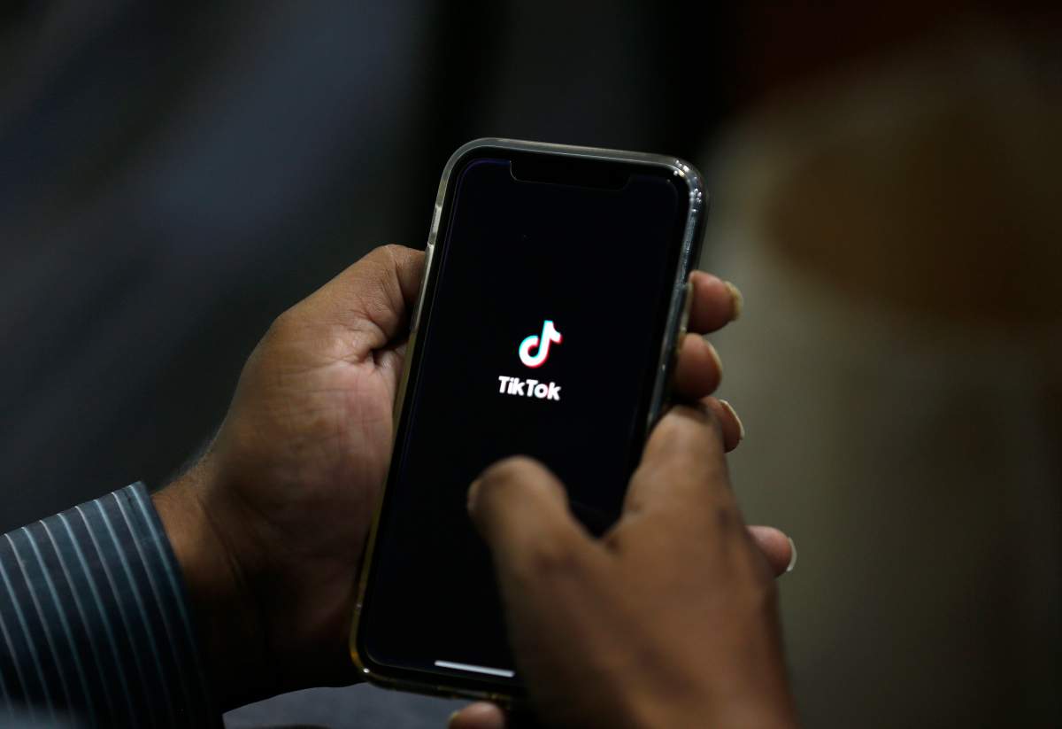 FILE - In this July 21, 2020 file photo, a man opens social media app 'TikTok' on his cell phone, in Islamabad, Pakistan.