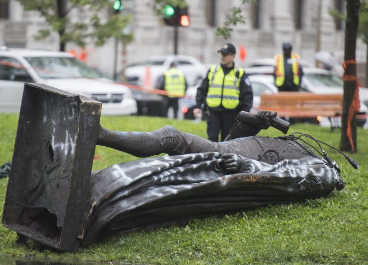 Police officers are shown at the scene next to the statue of Sir John A. MacDonald after it was torn down following a demonstration in Montreal, Saturday, Aug. 29, 2020, where people protested to defund the police with a goal to end all systemic racism within all sectors of the Canadian government. 