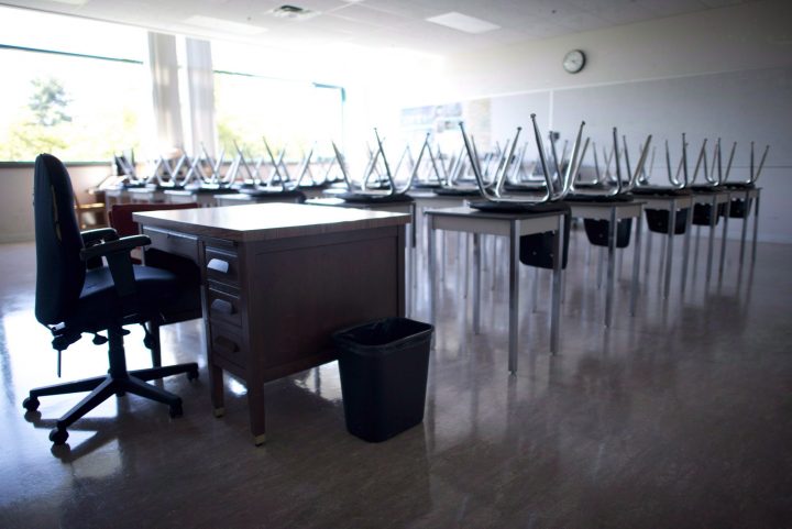 A empty teachers desk is pictured at the front of a empty classroom at Mcgee Secondary school in Vancouver on Sept. 5, 2014. 