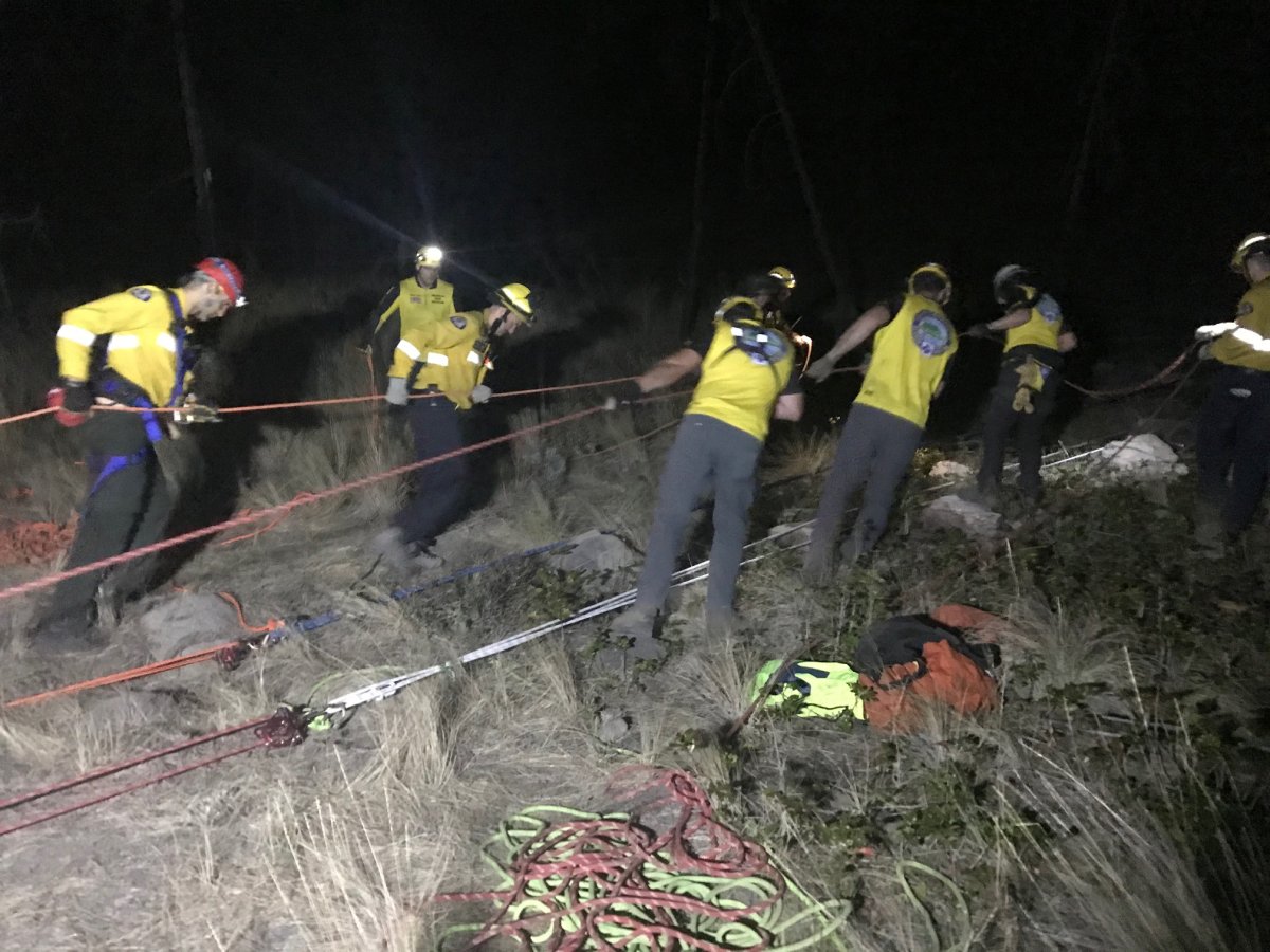 Members of Central Okanagan Search and Rescue pull on ropes during a high-angle rescue on Friday evening.