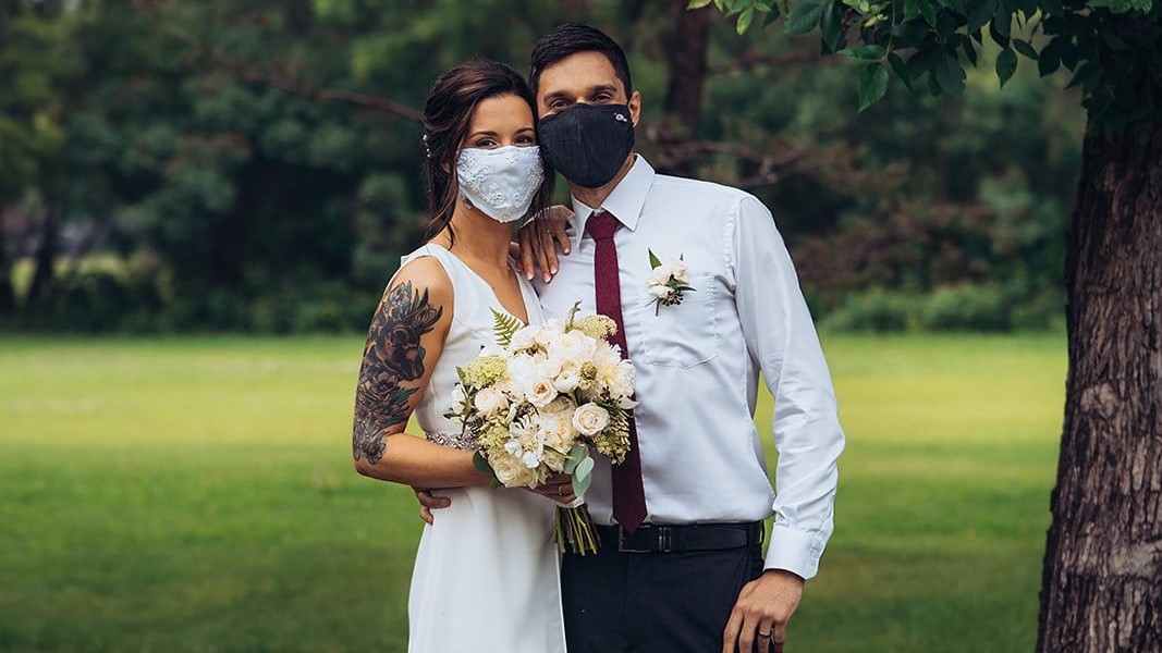 Dani Mario and Dustin Wawrrk with the masks they wore at their wedding.
