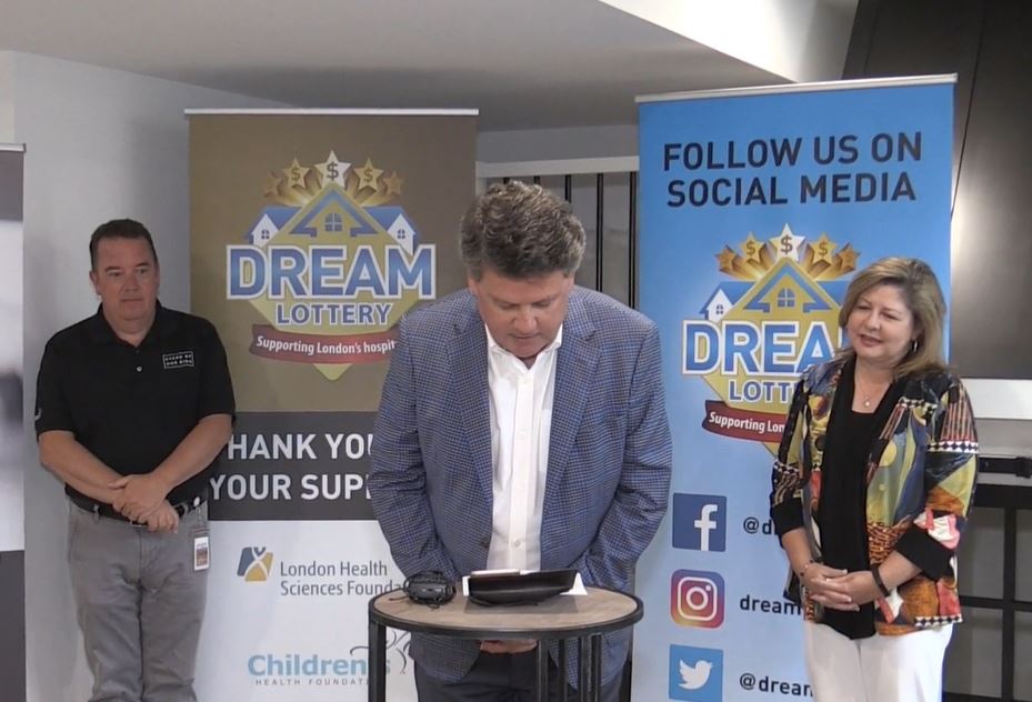 Scott Fortnum, CEO of Children's Health Foundation, seen standing on the left. Michelle Campbell, of the St. Joeseph's Hospital Foundation, seen standing to the right. John MacFarlane, CEO of London Health Sciences Foundation, seen centre, calling Grand Prize winner Ken McCann.