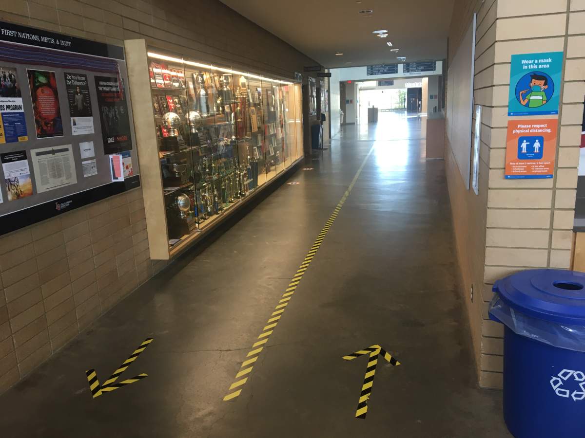 Arrows and lane markers direct foot traffic at Lillian Osborne High School in Edmonton, Alta.