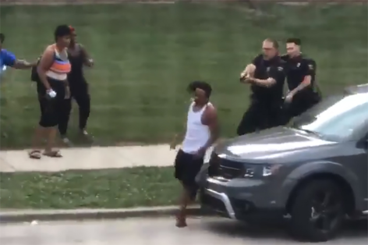 Jacob Blake, centre, walks away from police before he is shot in the back in Kenosha, Wisc., on Aug. 23, 2020.