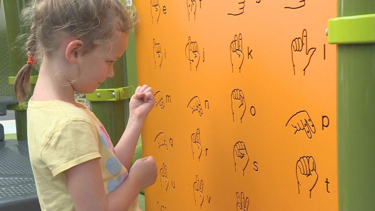 A child stops in front of a sign language panel in Tony-Proudfoot Park in Pointe-Claire on Tuesday, Agust 25, 2020. Phil Carpenter/Global News