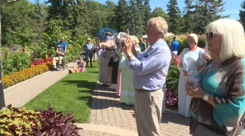 Dwight MacAuley photographing Sunday’s performance at Assiniboine Park, along with dozens of spectators.