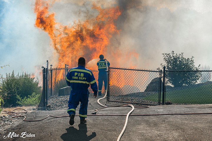 Two firefighters from the Penticton Indian Band battling the wildfire.