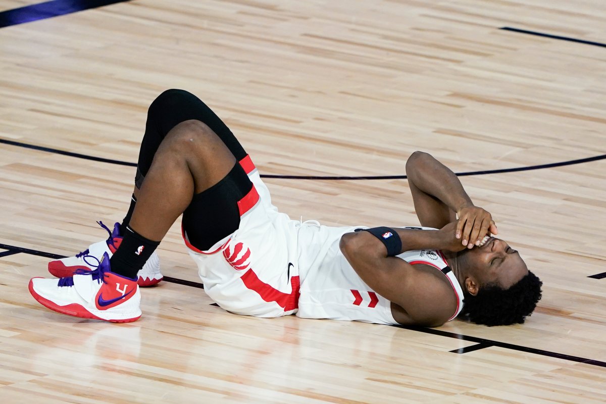 Toronto Raptors' OG Anunoby lies on the court after a collision during the second half of an NBA basketball conference semifinal playoff game against the Boston Celtics Sunday, Aug. 30, 2020, in Lake Buena Vista, Fla.