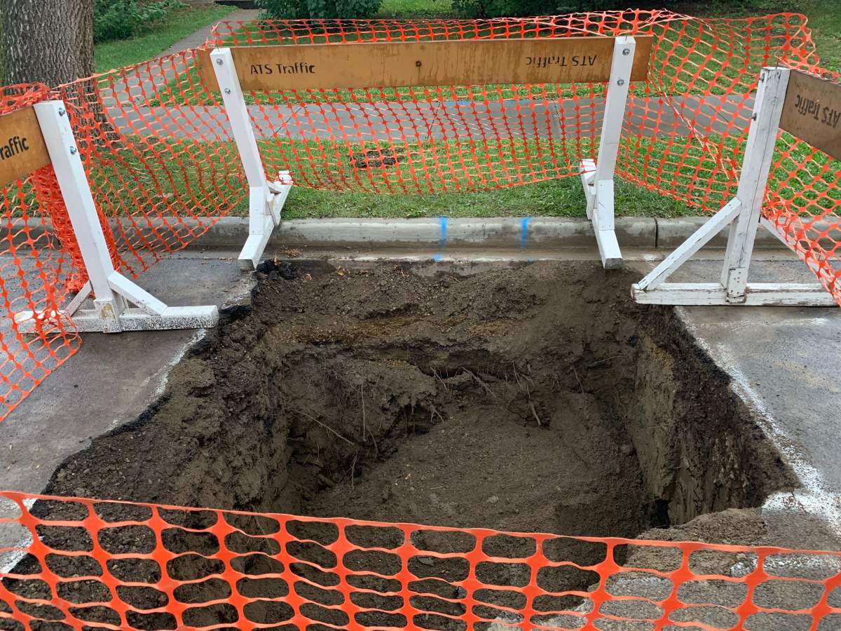 Epcor crews repair sink hole in Edmonton's Bonnie Doon neighbourhood, Saturday, Aug. 22, 2020. 