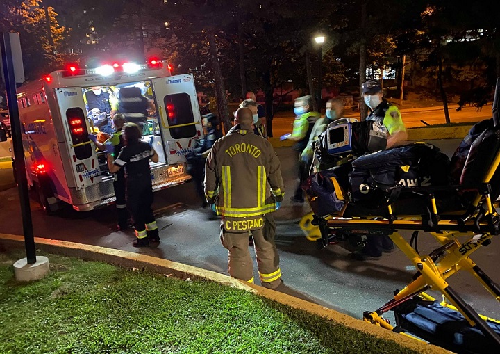 Toronto Paramedics prepare to transport a shooting victim from a scene near Crescent Place.