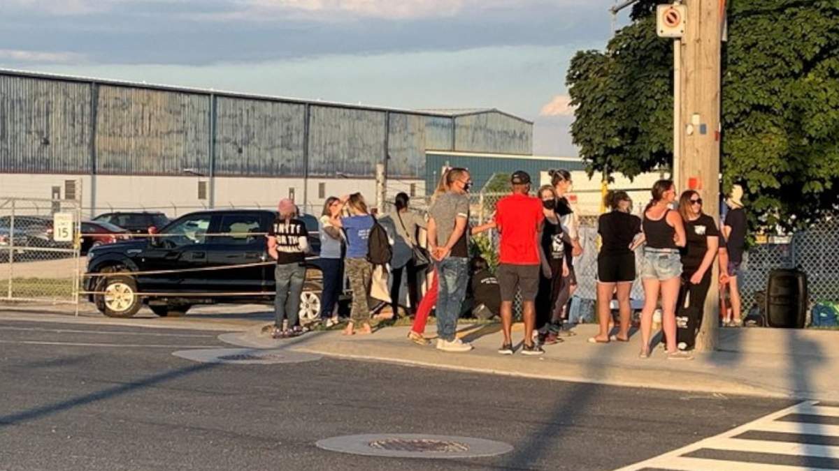 Residents gather outside of the Fearman's pork facility in Burlington Friday June 19, 2020.