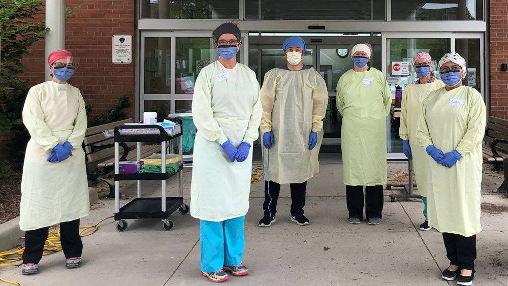 Staff outside of a COVID-19 Assessment Centre in London in August 2020.
