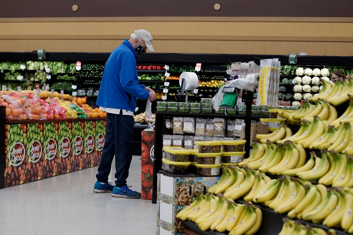 A shopper wears mask and gloves to protect against coronavirus, as he shops at a grocery store in Mount Prospect, Ill., Wednesday, May 13, 2020.