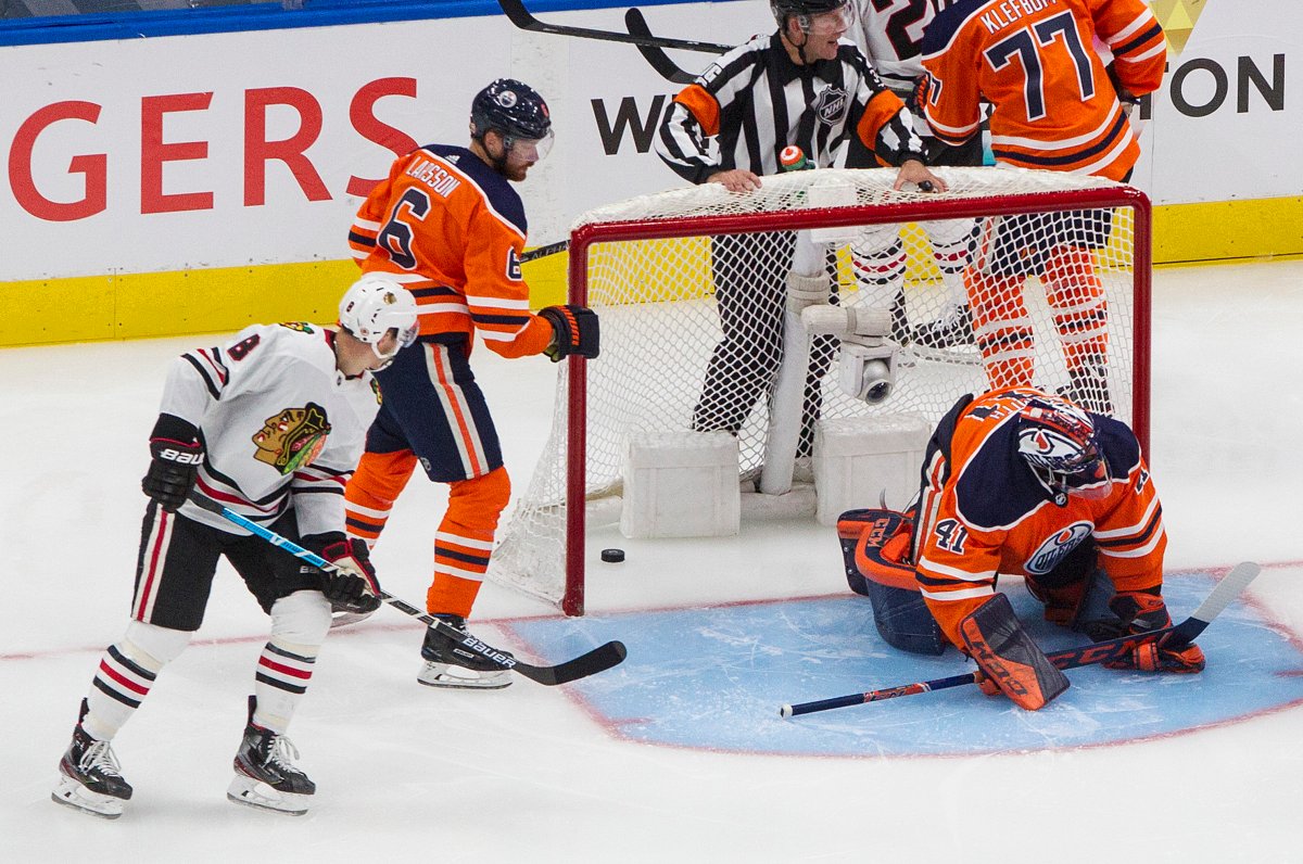 Edmonton Oilers goalie Mike Smith (41) is scored on as Adam Larsson (6) and Chicago Blackhawks' Dominik Kubalik (8) look for the puck during second period NHL playoff action in Edmonton, Saturday, Aug. 1, 2020. THE CANADIAN PRESS/Jason Franson.