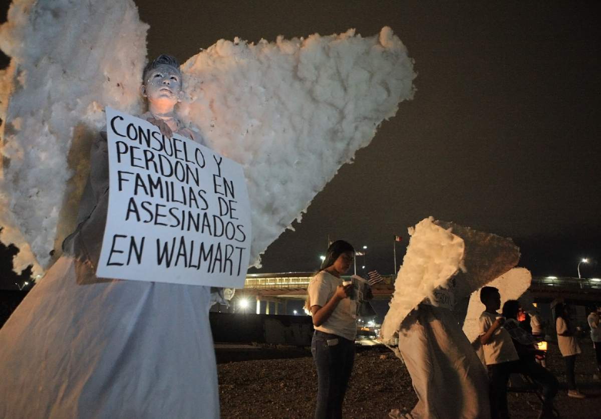 Members of the evangelical group Messenger Angels pray for the deceased and their families prior to the first anniversary of the massacre in a Walmart in El Paso, Texas, in the city of Juarez, in the state of Chihuahua, Mexico, Aug. 2, 2020. The poster reads “comfort and forgiveness in families with victims killed in Walmart.”