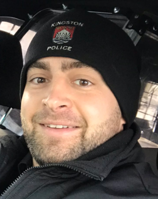 Kingston police officer Fil Wisniak has been named a hero of the year by the Ontario Police Association for his actions during a downtown shooting last year.