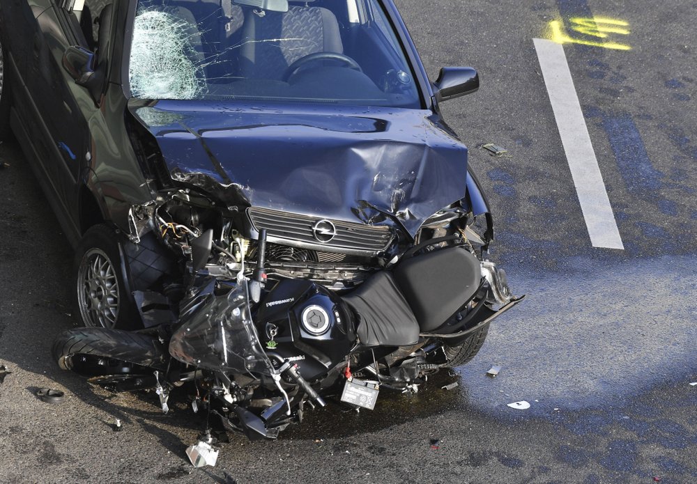 A car and a motorcycle stand on the city motorway A100 after an accident in Berlin, Germany, Wednesday, Aug. 19, 2020. The city's highway was still shut down after a series of traffic accidents that were allegedly all caused by one man.